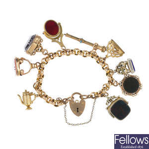 A bracelet with seven fobs, a propelling pencil and a charm.