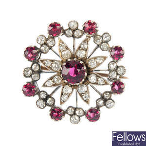A late 19th century silver and gold, garnet and diamond floral brooch.