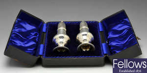 A cased pair of Edwardian silver casters.