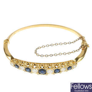 An 18ct gold sapphire and diamond bangle.