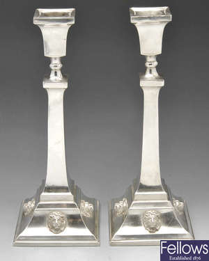 A pair of George V silver candlesticks.