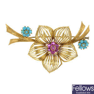A turquoise and ruby floral brooch.