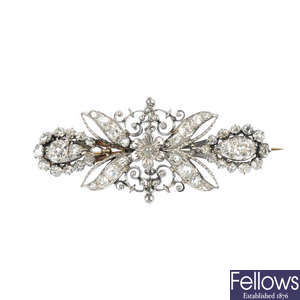 A diamond floral brooch.