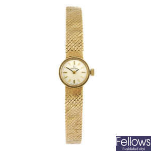 OMEGA - a lady's 9ct gold bracelet watch.