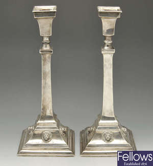 A pair of early 20th century silver candlesticks with lion mask motifs.