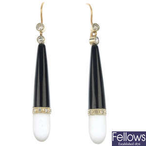 A pair of onyx and diamond ear pendants.