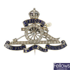 A mid 20th century 18ct gold and platinum diamond and enamel Royal Artillery brooch.