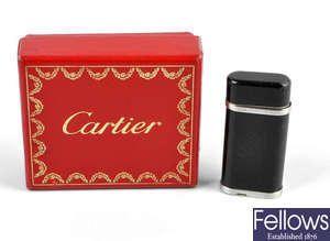 A Cartier black lacquered lighter