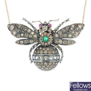 A diamond and gem-set insect pendant with chain.