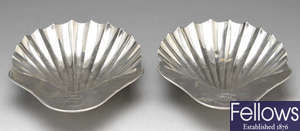 A pair of George III silver shell butter dishes.
