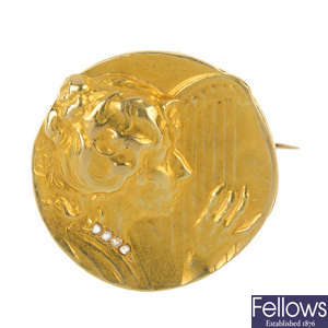 An Art Nouveau gold diamond medallist brooch.