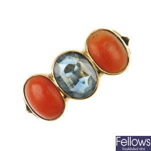 An early 20th century gold sapphire and coral three-stone ring.