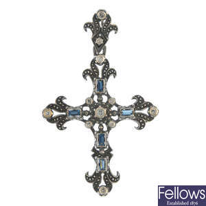A sapphire and diamond cross pendant.