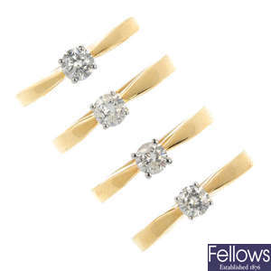 A selection of four 18ct gold diamond rings.