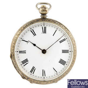 A white metal open face pocket watch with two other open face pocket watches.