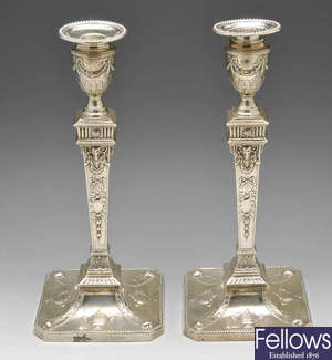 A pair of late Victorian Neoclassical revival silver candlesticks.