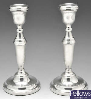 A modern pair of silver candlesticks.