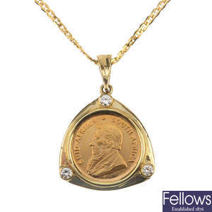 A diamond 1/10 Krugerand coin pendant and chain.