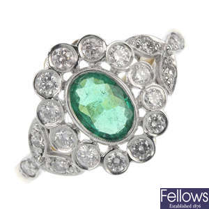 An emerald and diamond foliate cluster ring.