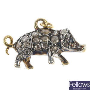 A diamond and sapphire pig pendant.
