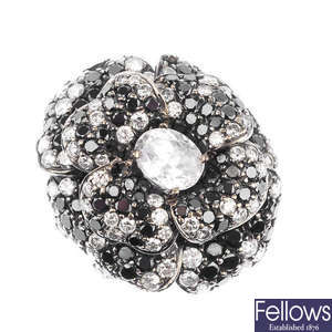 A diamond and gem-set floral ring.