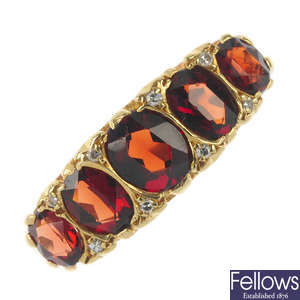 An 18ct gold garnet and diamond accent ring.