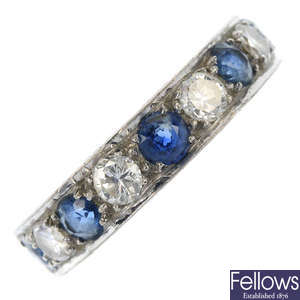 An 18ct gold sapphire and diamond half-circle eternity ring. 