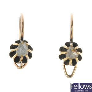 A pair of early 20th century gold diamond single-stone earrings.