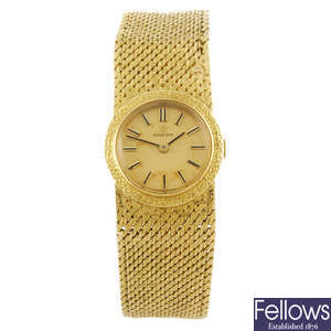 OMEGA - a lady's 18ct yellow gold bracelet watch.