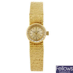 OMEGA - a lady's 18ct gold De Ville bracelet watch.