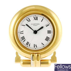 CARTIER - a gold plated travel clock. 