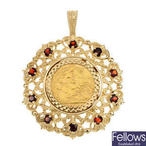 A 9ct gold and red-gem mounted half-sovereign pendant.