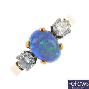 An 18ct gold black opal and diamond three-stone ring.