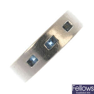 An 18ct gold gem-set band ring.