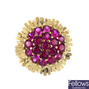 A synthetic ruby floral cluster ring.