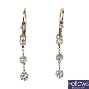 A pair of diamond four-stone ear pendants.