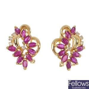 A pair of ruby and diamond foliate earrings.