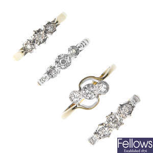 A selection of four mid 20th century gold diamond three-stone rings. 