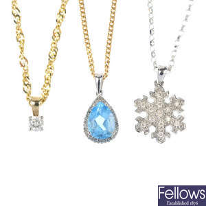 A selection of three 9ct gold gem-set pendants with chains.