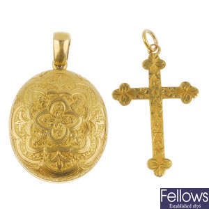 An early 20th century 15ct gold cross pendant and a gold locket.