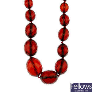 Two red plastic bead necklaces.