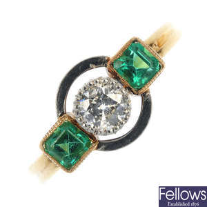 A diamond and emerald three-stone ring.