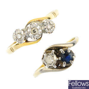 Two gem-set and diamond crossover rings.