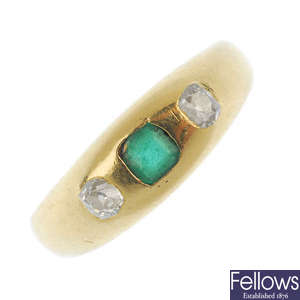 An early 20th century 18ct gold emerald and diamond three-stone ring. 