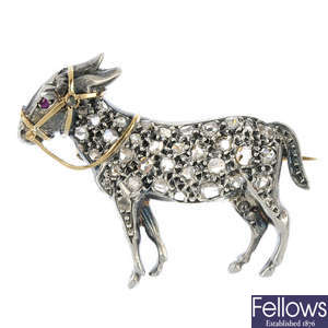 A late 19th century silver and 18ct gold diamond and ruby novelty donkey brooch.