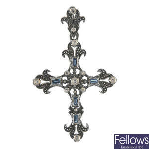 A sapphire and diamond cross pendant. 