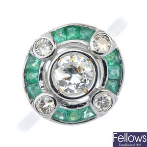 A diamond and emerald dress ring.