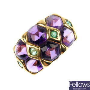 An amethyst and emerald dress ring.
