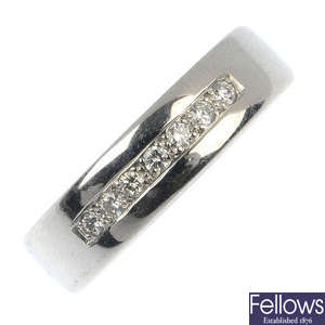 A platinum diamond seven-stone band ring.