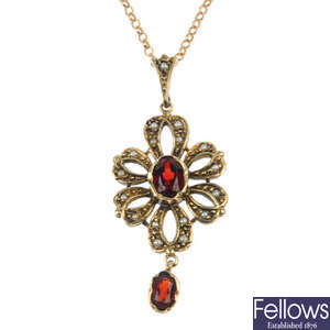A 9ct gold garnet and split pearl pendant.